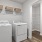 washer and dryer with shelves above