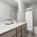 bathroom with bathtub and large mirror
